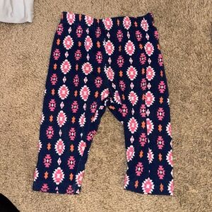 Nannette kids blue pants with pink n orange pattern all over. Size 9-12 months